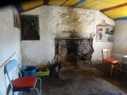 Bright colours and paintings ON the walls in Strathchailleach bothy.